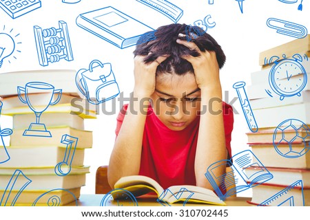Tensed boy sitting with stack of books against school doodles