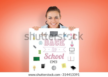 Smiling businesswoman looking over wall against orange