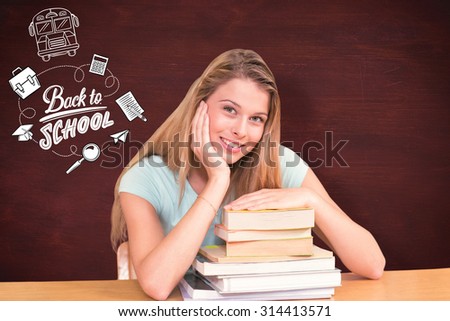 Portrait of female student in library against desk