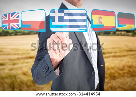 Businessman pointing with his finger against hill with trees