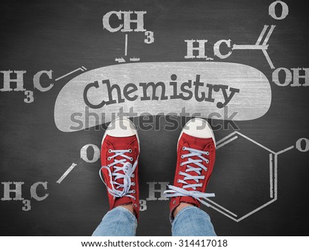 The word chemistry and casual shoes against black background