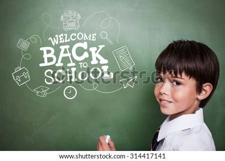 back to school against cute pupil holding chalk