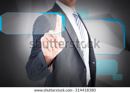 Businessman pointing with his finger against abstract grey room