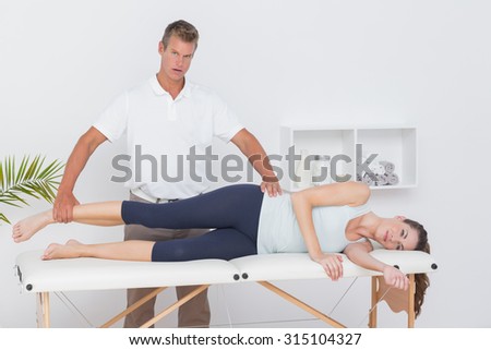 Doctor examining his patient legs in medical office