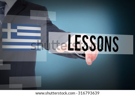 The word lessons and businessman in suit pointing his finger against blue background