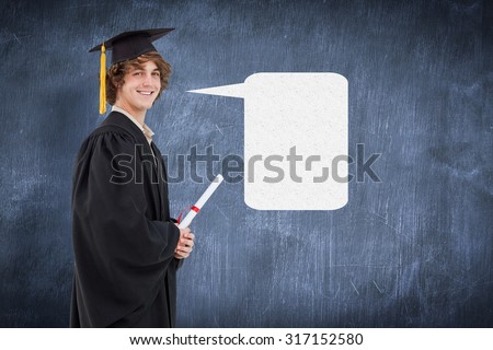 Profile view of a student in graduate robe against blue chalkboard