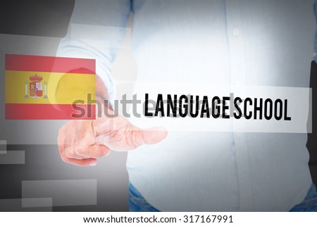 The word language school and man pointing something with his finger against abstract white room