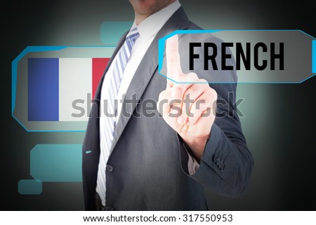 The word french and businessman pointing with his finger against green background with vignette