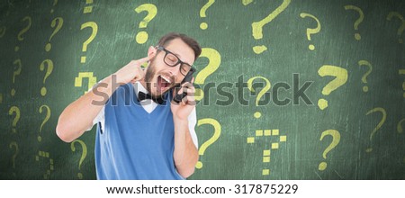 Geeky hipster talking on a retro cellphone against green chalkboard