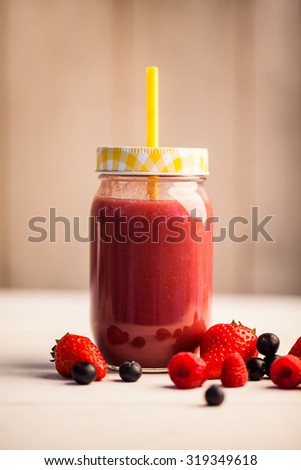Mixed berry juice in a jar on the table