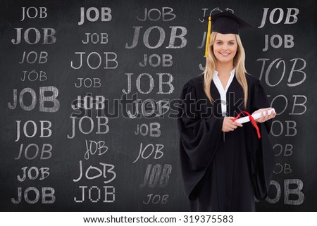 Smiling blonde student in graduate robe holding her diploma against blackboard