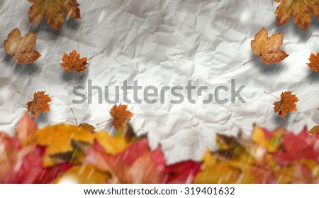 Autumn leaves against crumpled page