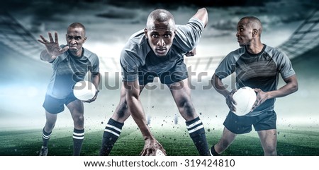 Rugby player with ball running against rugby stadium