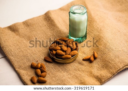 High angle view of almonds and milk jar on sack