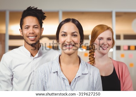 Portrait of confident smiling colleagues standing in office