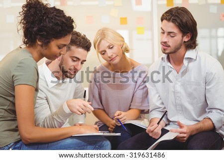 Colleagues interacting with each other at a meeting