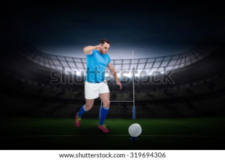 Rugby player ready to kick against rugby stadium