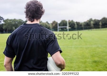Rugby player looking at posts at the park