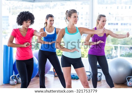 Women stretching hands at fitness studio