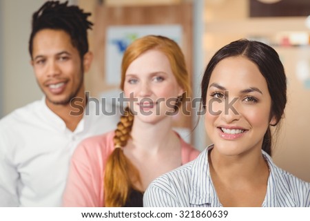 Portrait of confident colleagues smiling at office