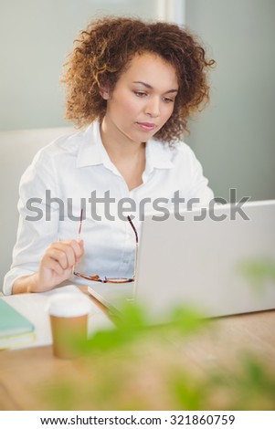 Businesswoman working in office with the help of laptop