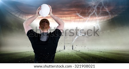 Rugby player about to throw a rugby ball against rugby pitch