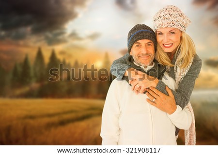 Portrait of wife embracing husband against country scene