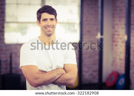 Portrait of smiling muscular man looking at camera in crossfit gym