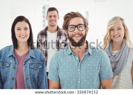 Portrait of smiling business professionals standing in office