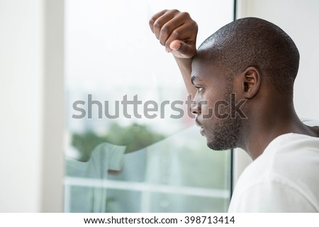 Similar – Image, Stock Photo Depressed man looking through window