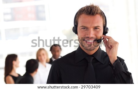 Young Businessman with a headset on in office environment