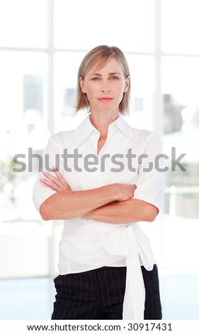Serious mature businesswoman with folded arms