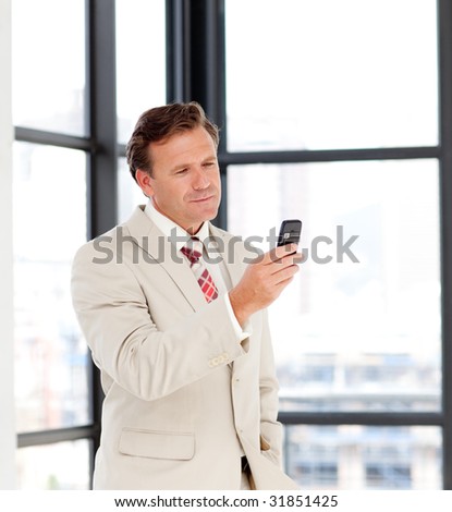 Portrait of a mature businessman sending a text on a mobile phone