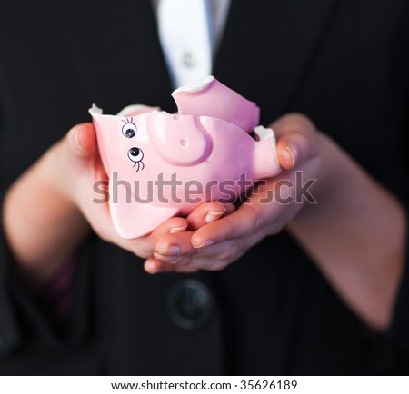 Young Business woman holding a broken piggy bank