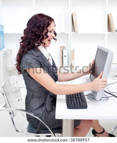 Frustrated businesswoman in office using a computer