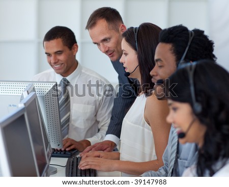 Manager helping his business team working in a call center