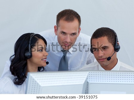 Manager helping business people working in a call canter