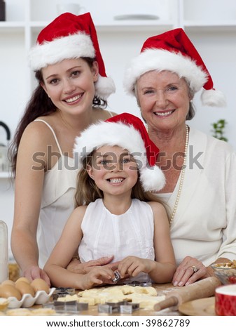 Daughter, mother and grandmother baking Christmas sweets in the kitchen