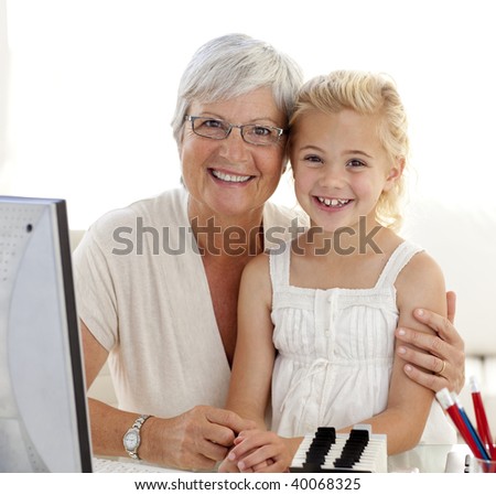 Portrait of granddaughter and grandmother using a computer at home