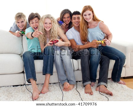 Friends having fun playing video games in the living-room