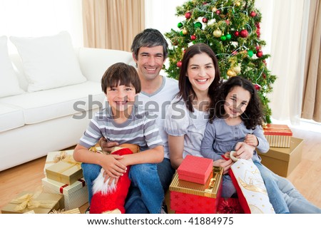 Young family having fun with Christmas presents