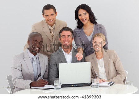 Multi-ethnic business team working in the office with a laptop