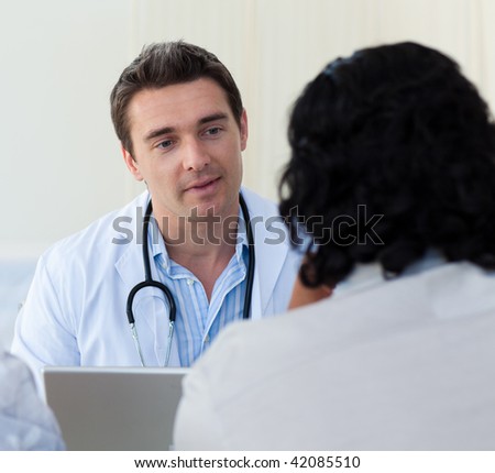 Male doctor explaining diagnosis to a patient during a visit