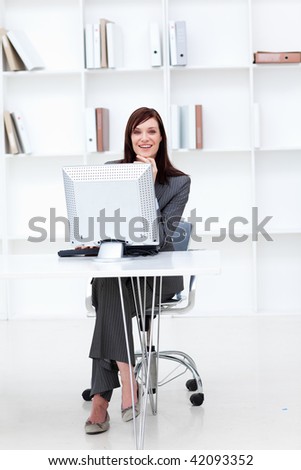High angle of a smiling businesswoman working at a computer in the office