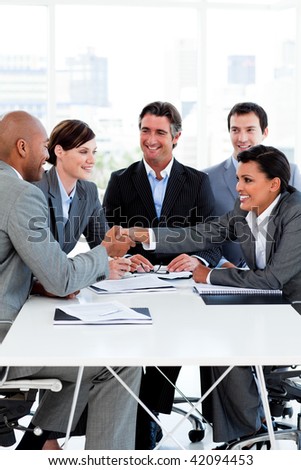 Successful international business people shaking hands in the office