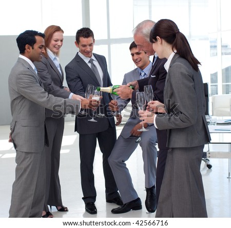 Successful businessman serving Champagne to his colleagues after a success