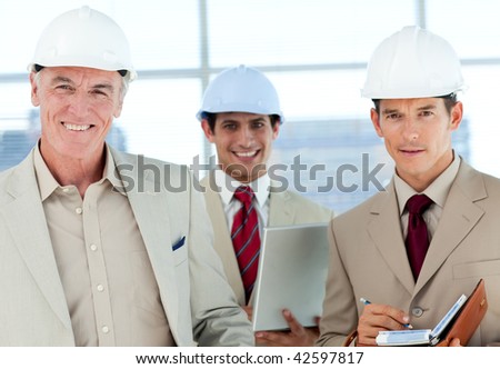 A group of architect smiling at the camera in a building