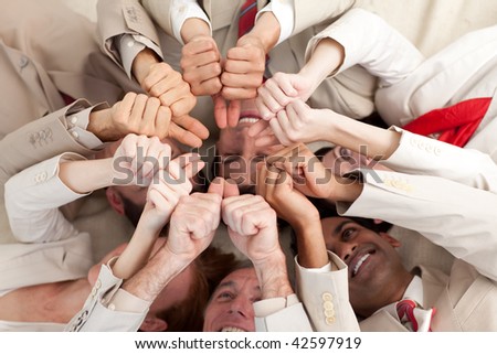 Successful business team with thumbs up lying on the floor in a circle
