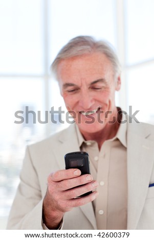 Senior manager sending a text in a business building