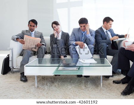 International business people sitting in a waiting room. Business concept.